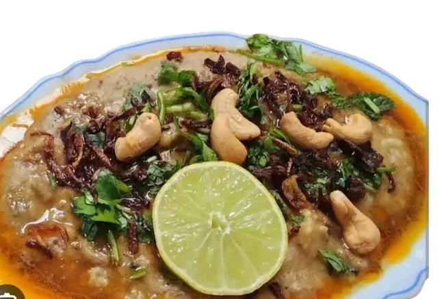 Mutton haleem topped with fried onion, cashews and lime